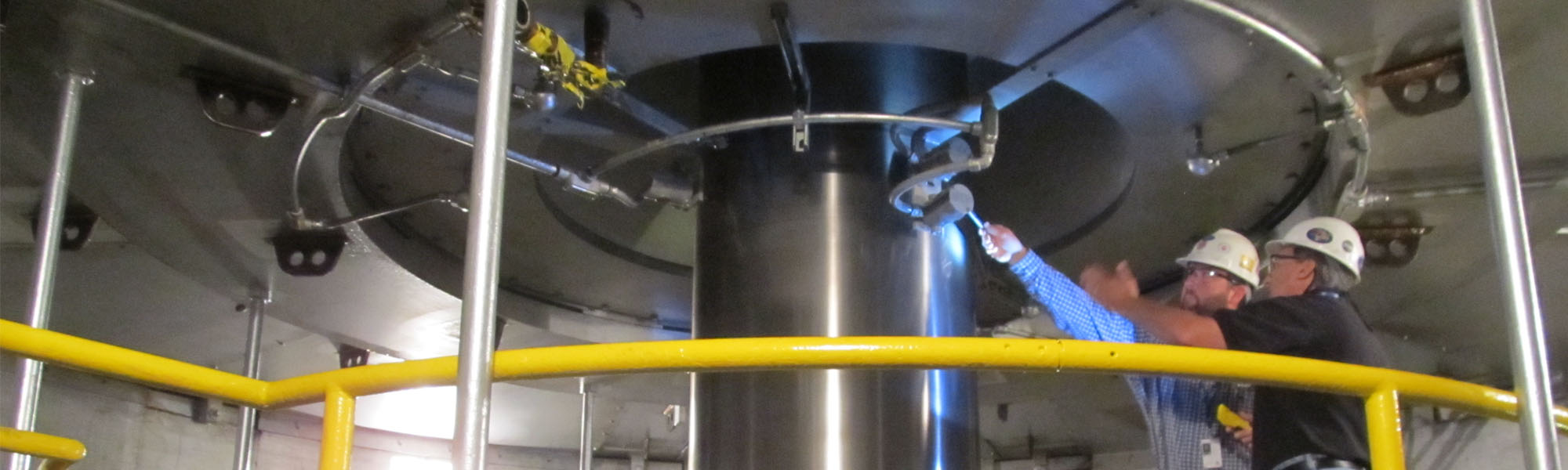 Workers inspecting hydro turbine