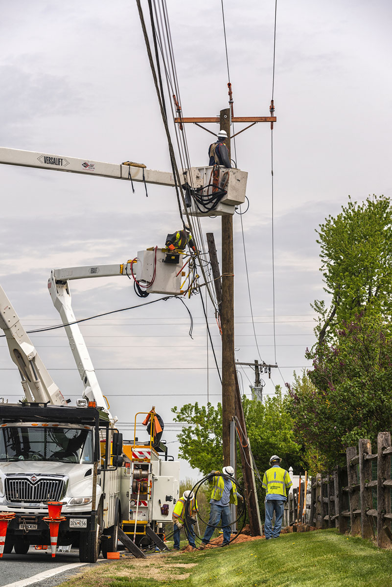 Linemen working to replace old telephone pole and transformer