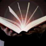 Light coming from book in womans hands in gesture of giving offering Concept of wisdom religion reading imagination